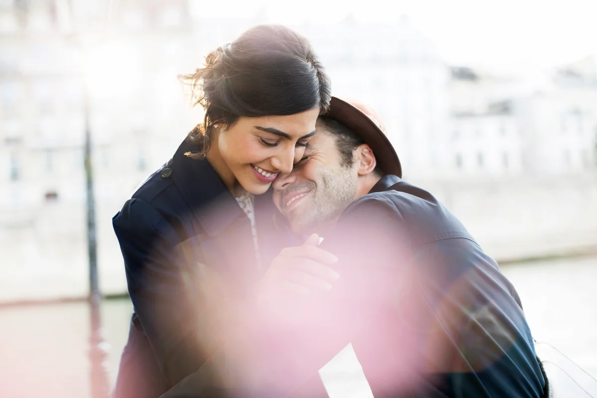 Couple hugging along Seine River
