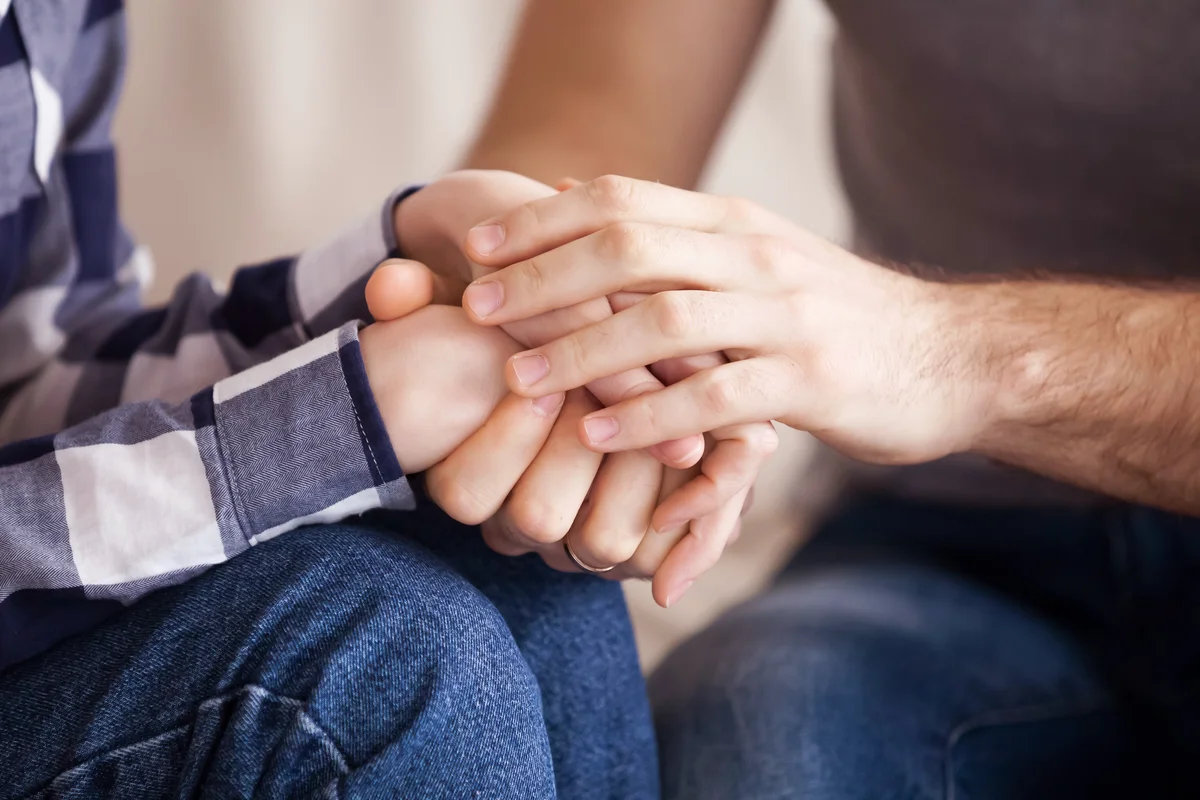 Couple holding hands reconciled after fight