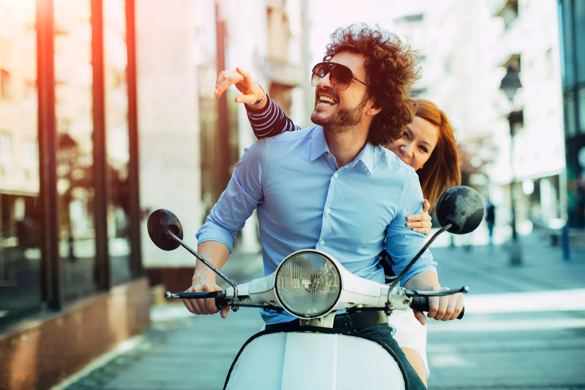 Young Couple Riding On A Motorbike
