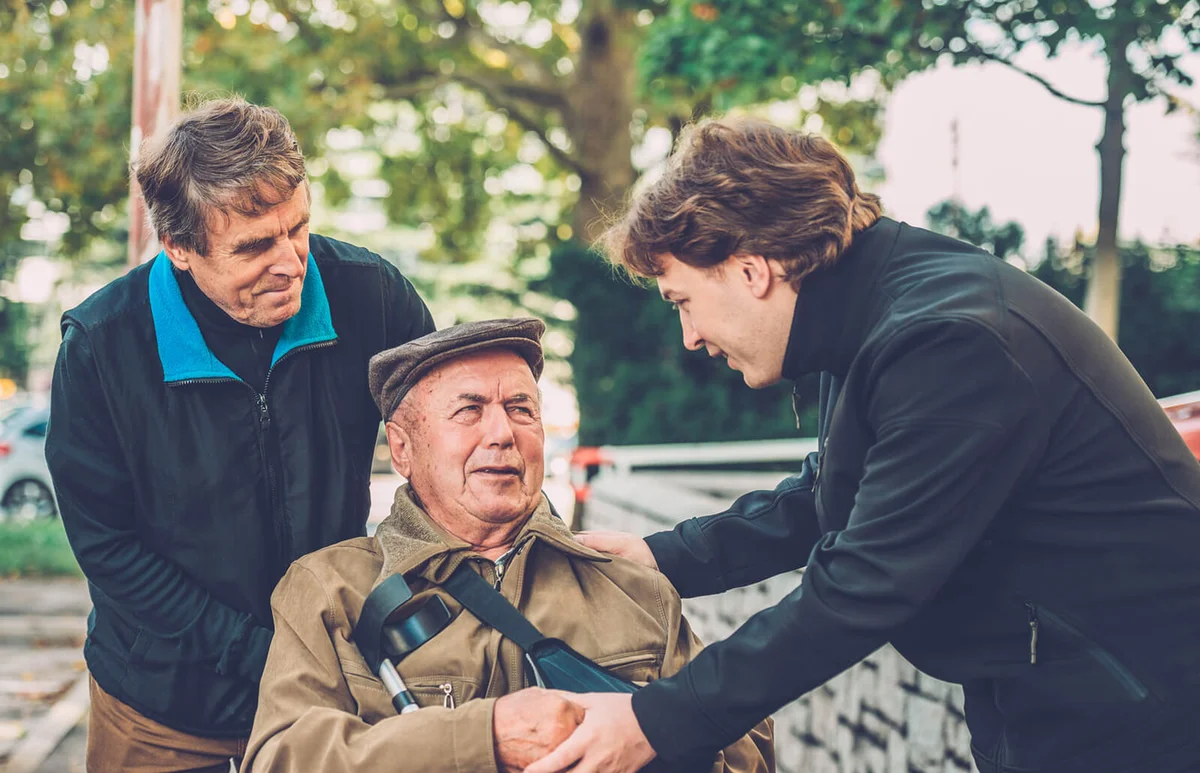 Senior Man in Wheelchair with his Son and Grandson