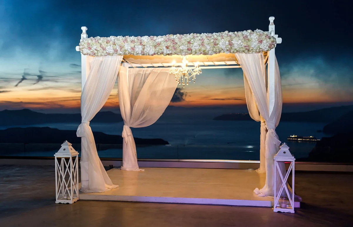 Wedding ceremony evening with lamps in the on the coast of the sea