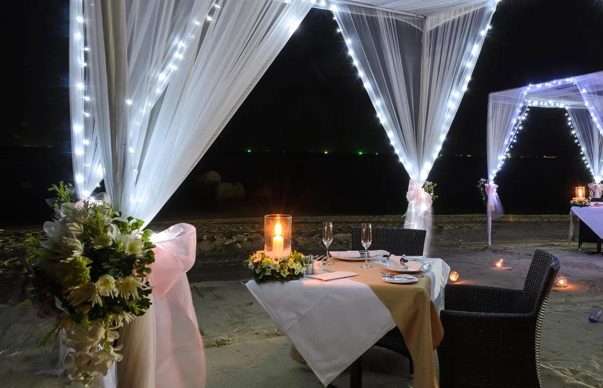 Romantic dinner setup on beach at night