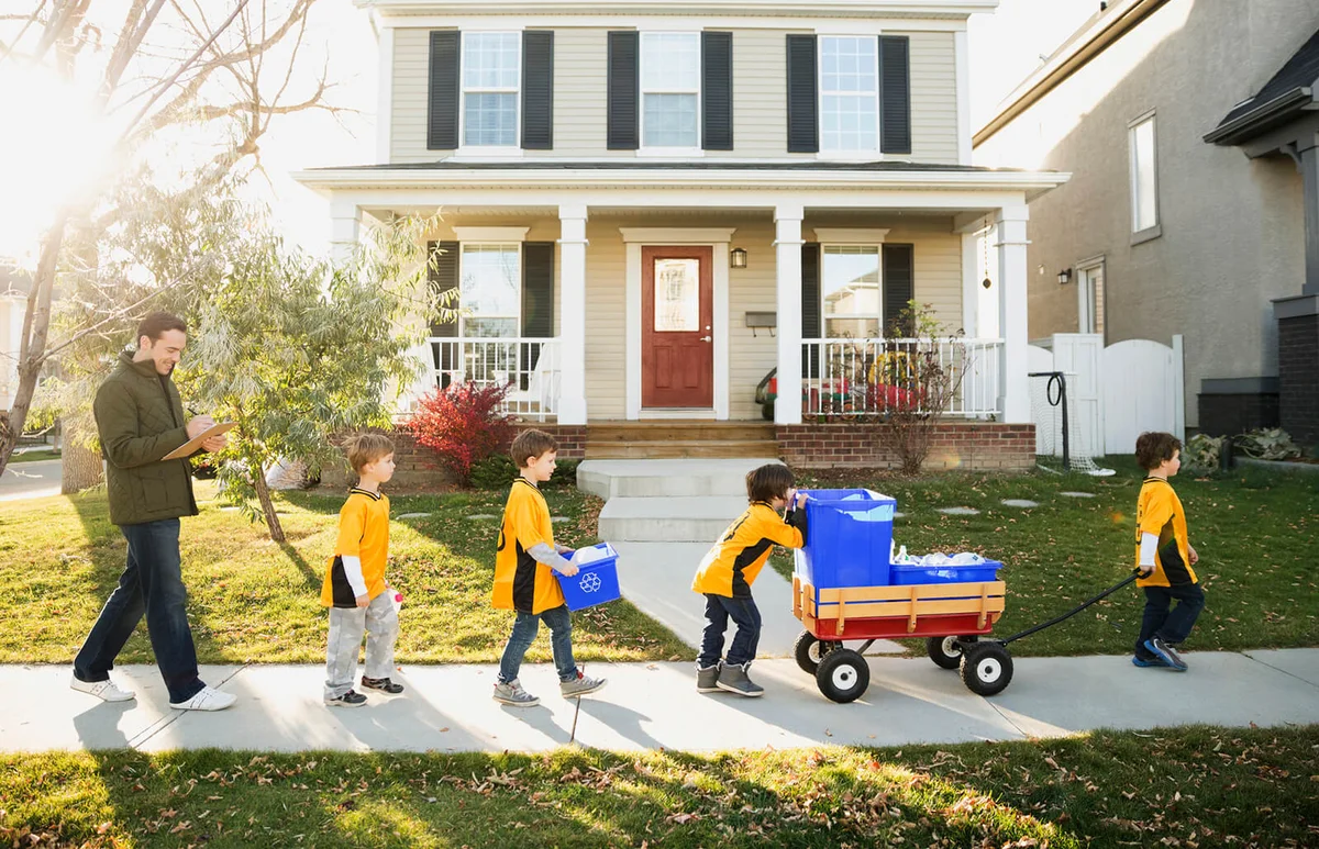 Coach and boys sports team gathering recycling neighborhood