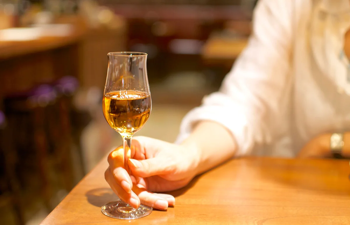 Woman holding a glass of sherry