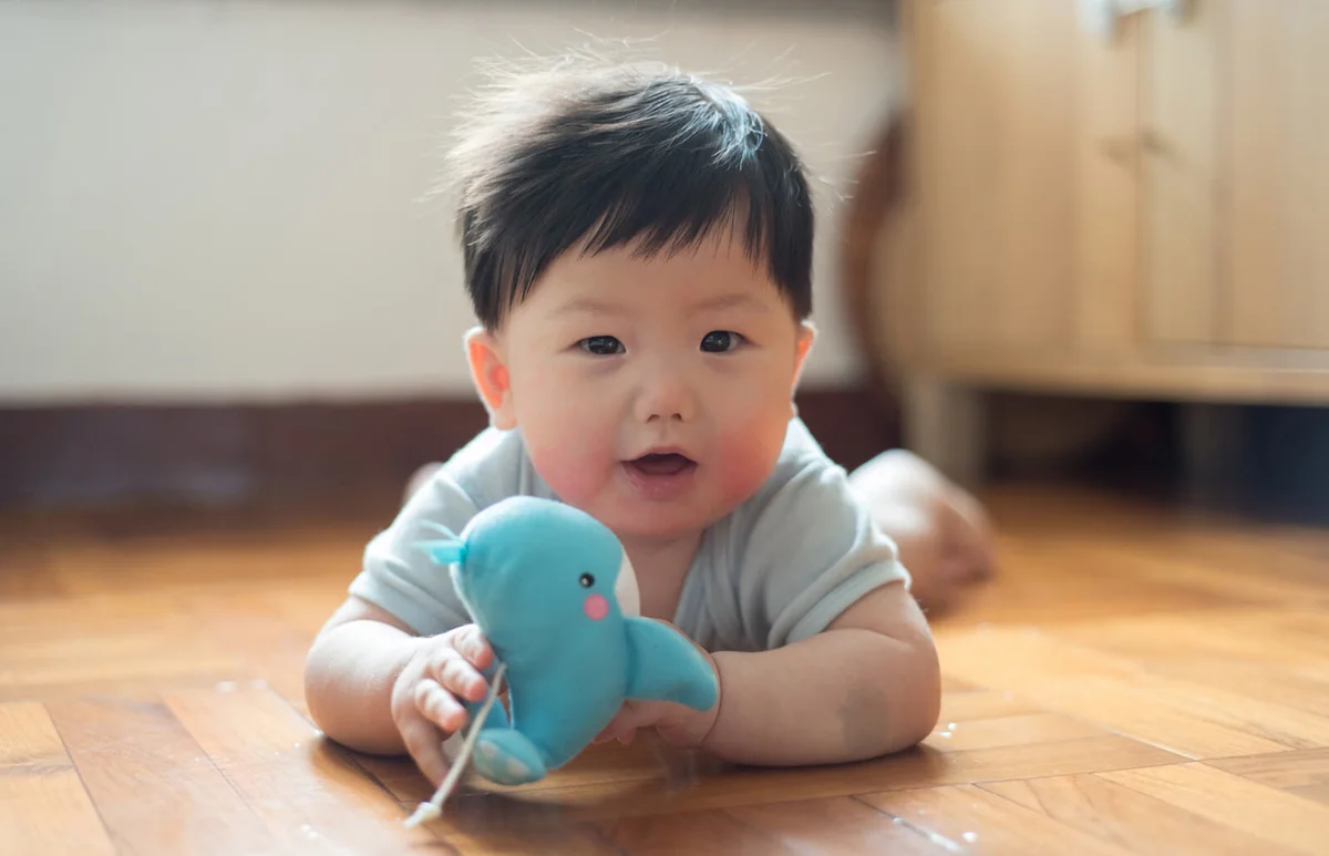 Baby boy playing toy whale