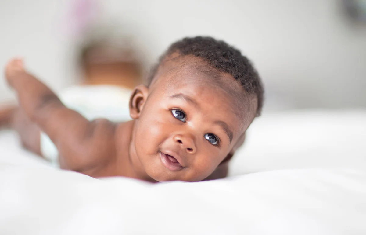 baby laying on bed