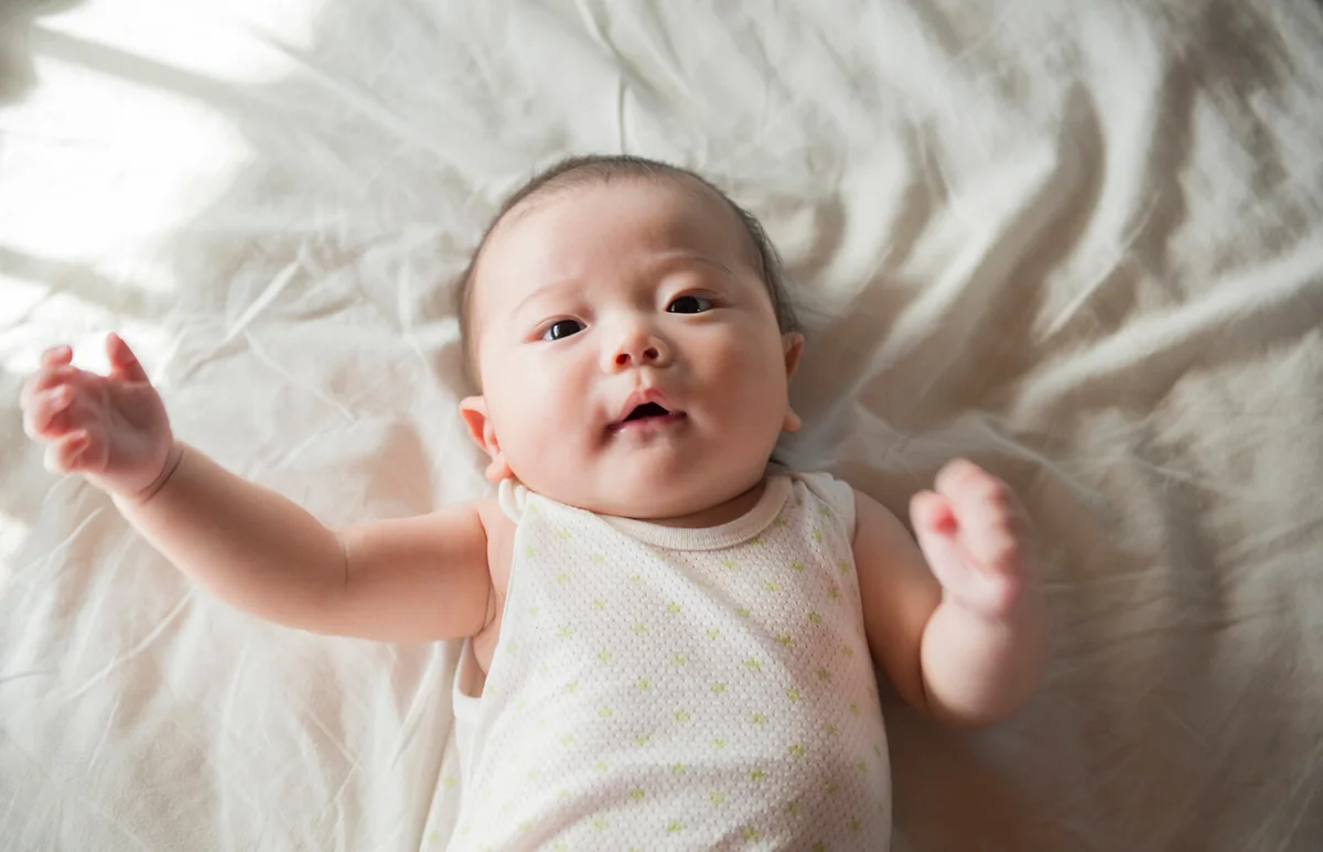 baby holds out its arm