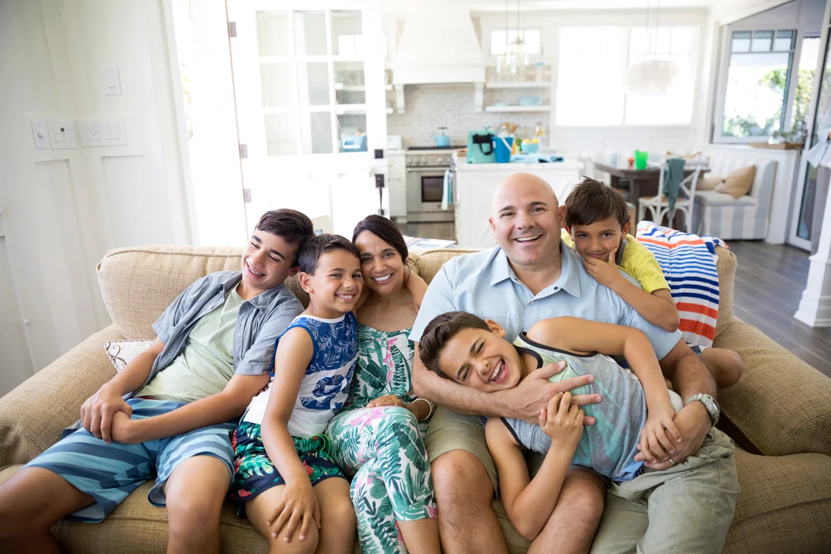 Smiling family in beach house living room