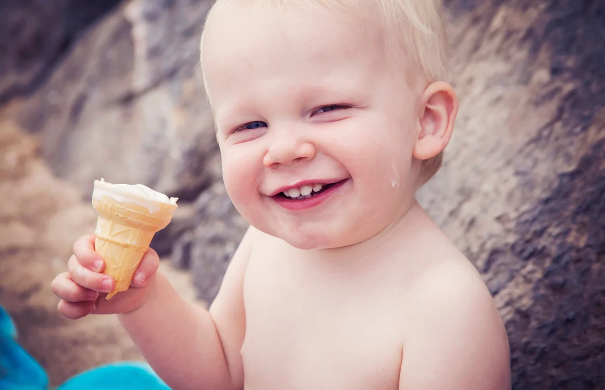 Smiling child eating ice cream