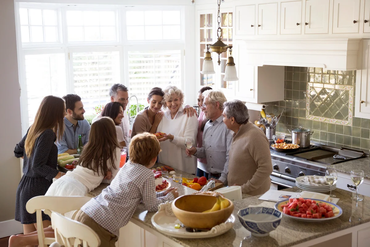 Multi-generation family surrounding kitchen island