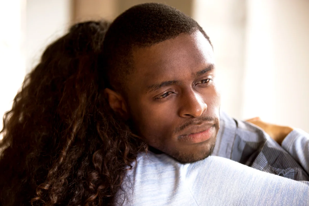 Woman embracing sad frustrated man