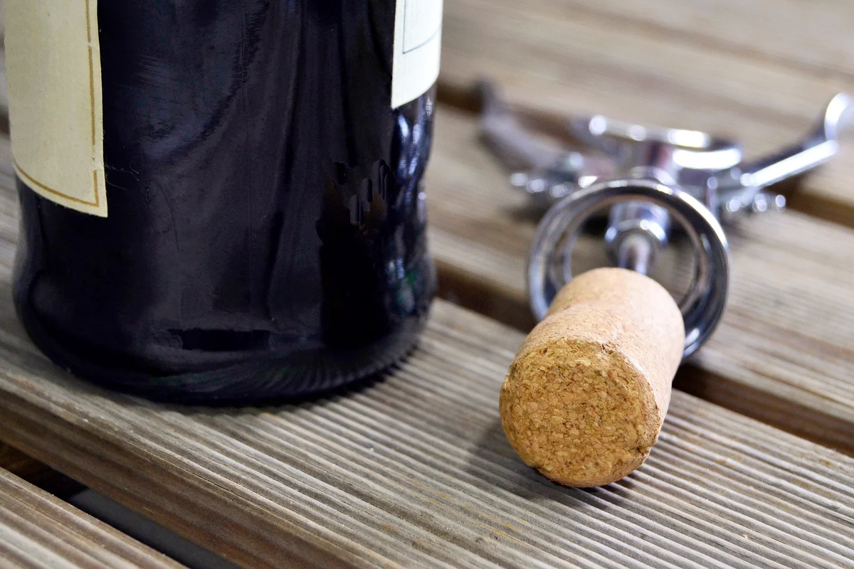 Red wine bottle with corkscrew