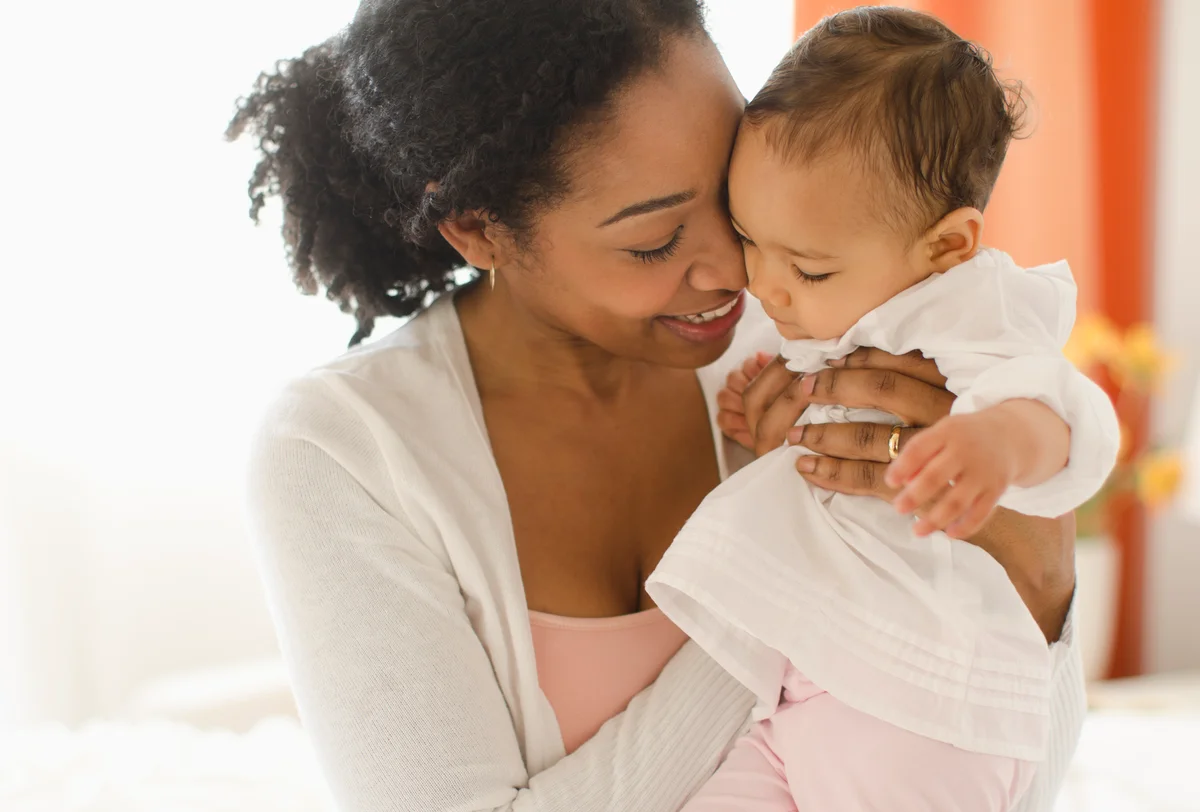 Mixed race woman holding baby