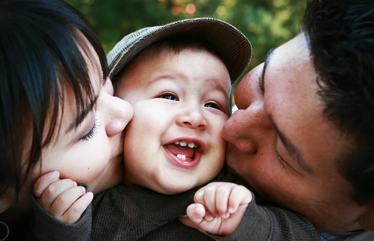 Playful mother holding son outdoors