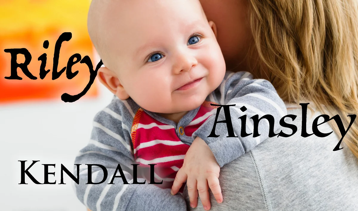 Mother holding baby son over shoulder