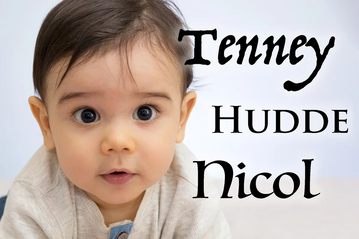Cute Baby Boy On Bed Against Wall At Home