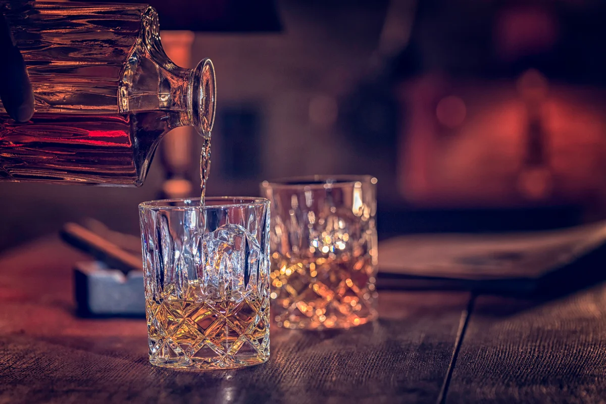 pouring bourbon into glasses