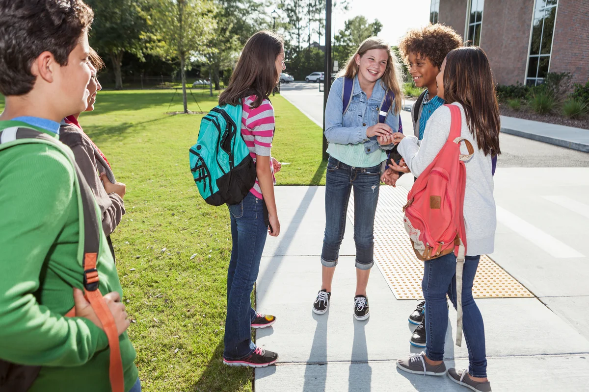 Group of students standing outside school building