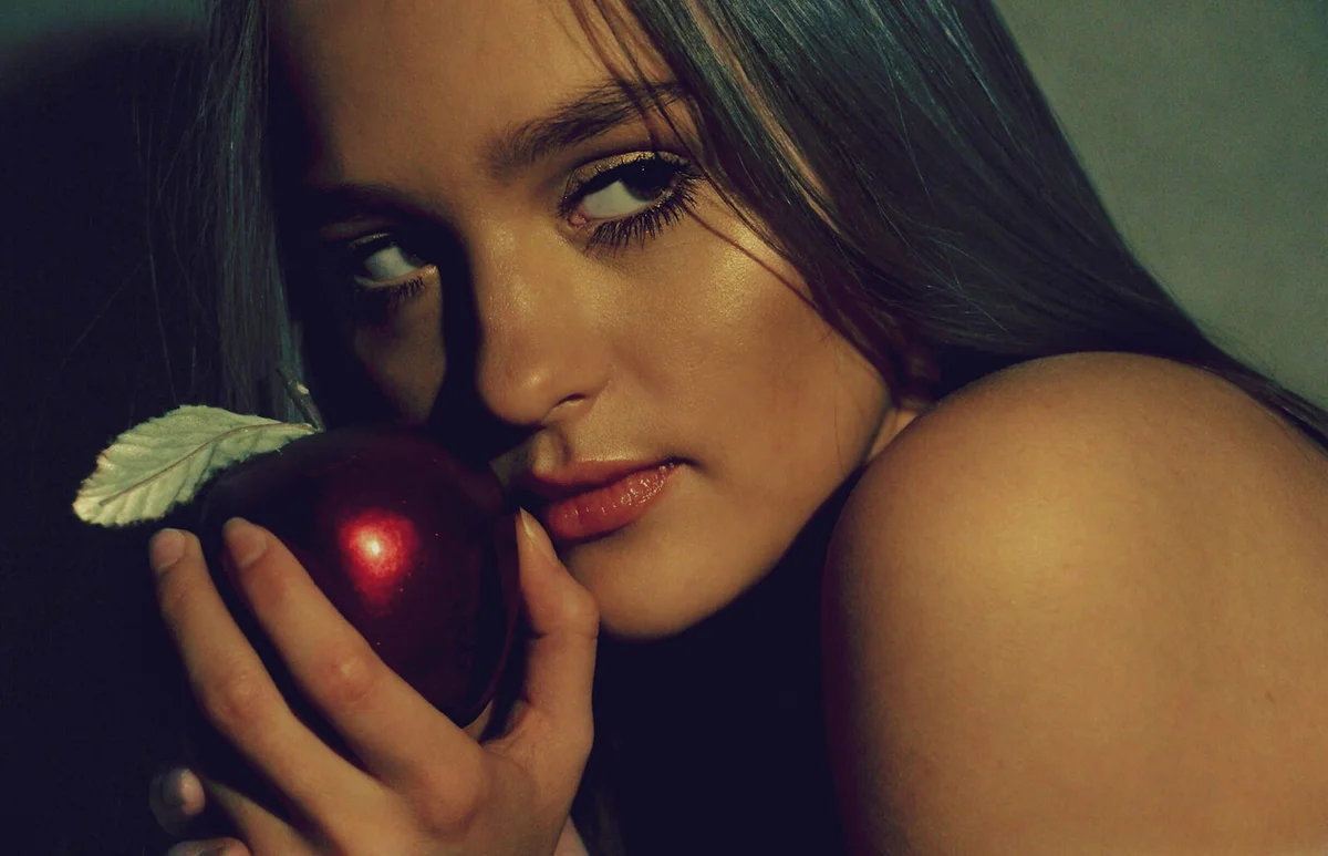 Young Woman Holding Artificial Shiny Apple