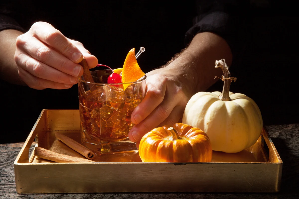 Preparing Old Fashioned Whiskey Cocktail on bar counter