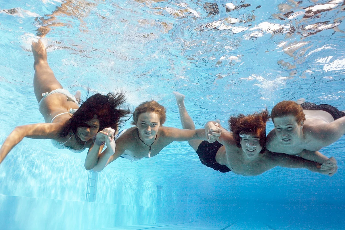 Teens swimming underwater