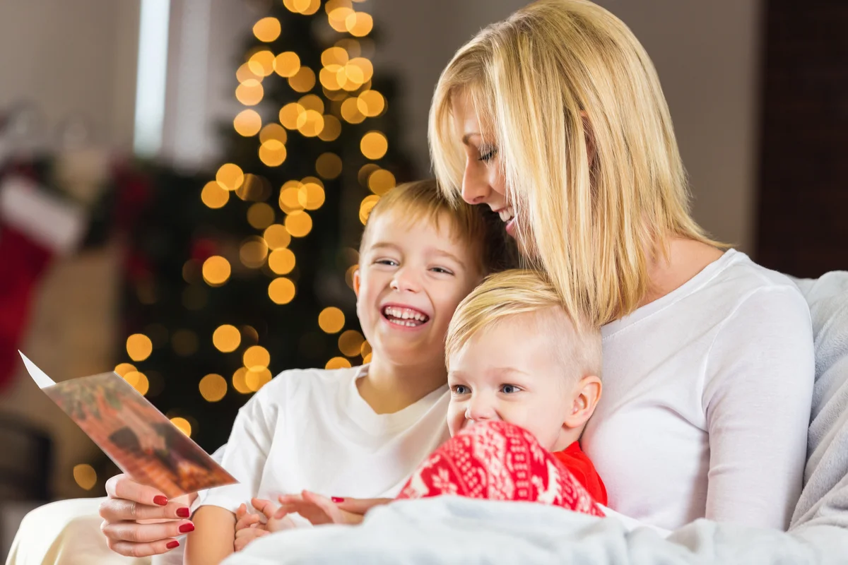 Mother looking at Christmas card with adorable little boys