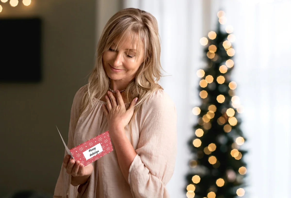 Woman reading a heartfelt message in a card at Christmas