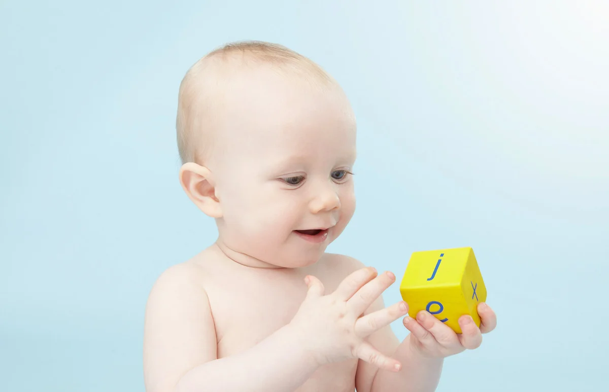 Baby looking at alphabet cube
