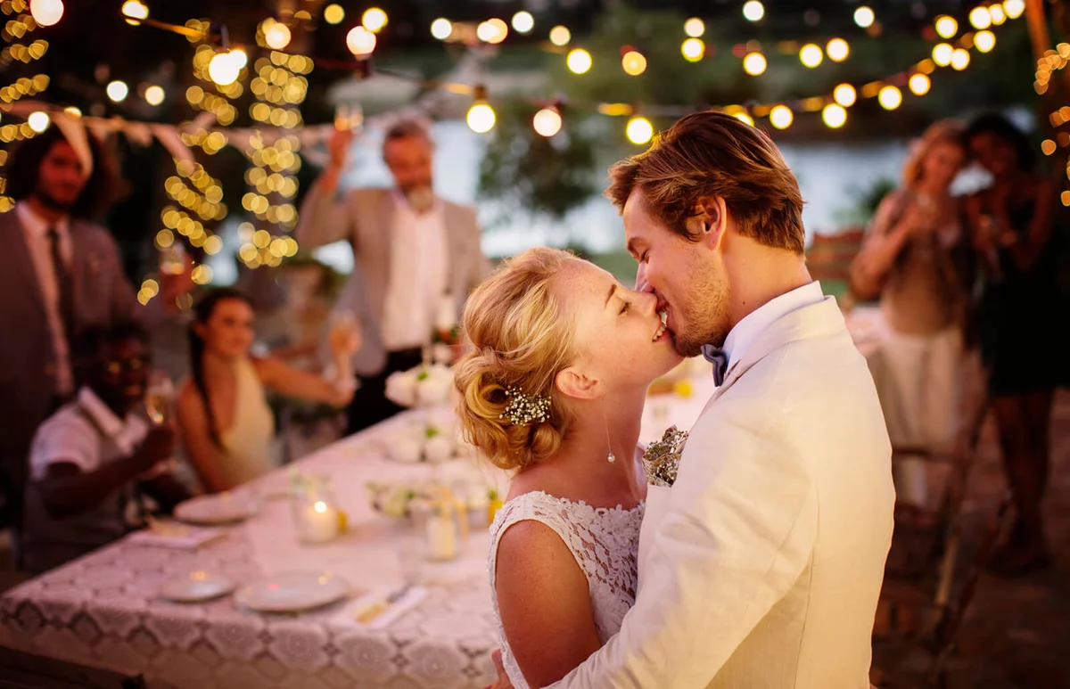 couple kissing during wedding reception