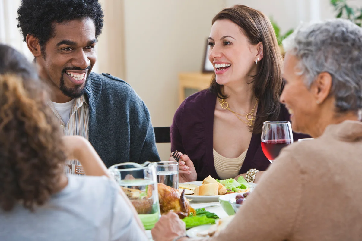 Family talking and enjoying Thanksgiving dinner