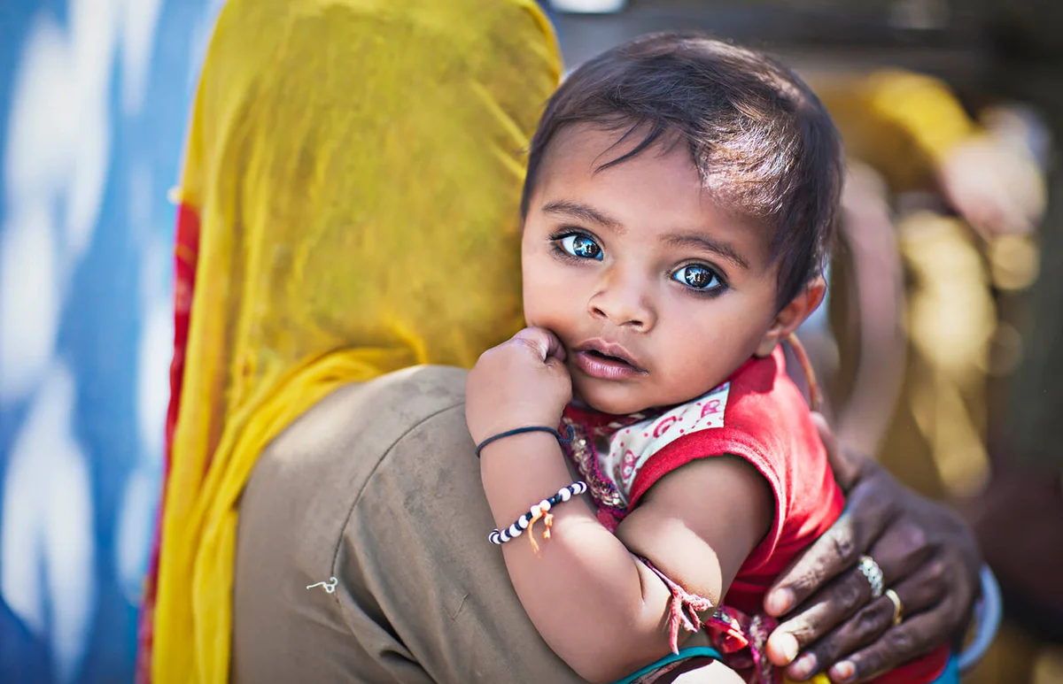 Portrait of an indian child in the arms of the mother
