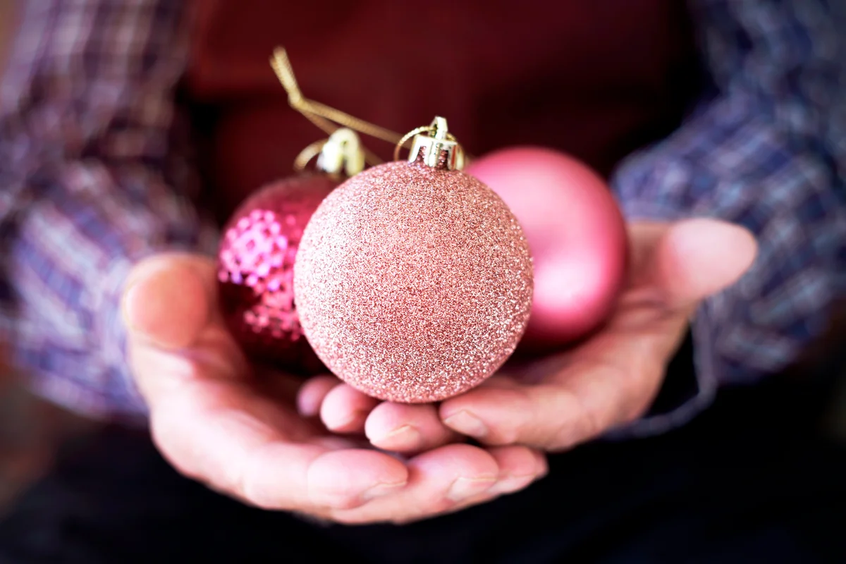 Old man with christmas balls in his hands