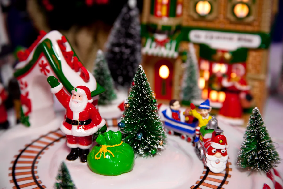 Miniature Christmas scene with Santa and toy bag trai