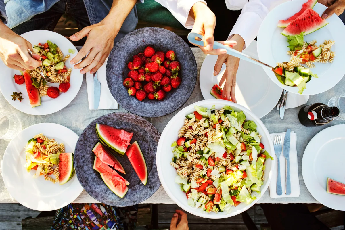 Friends enjoying lunch at picnic table