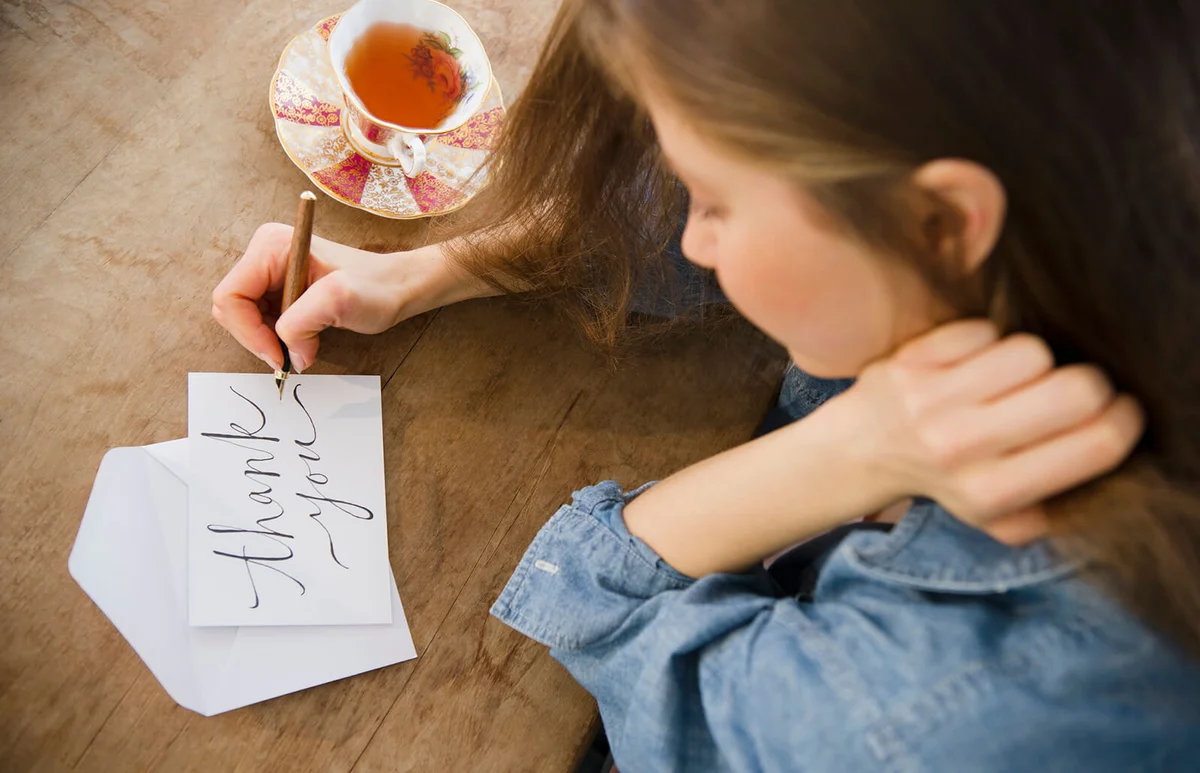 Woman writing greeting card