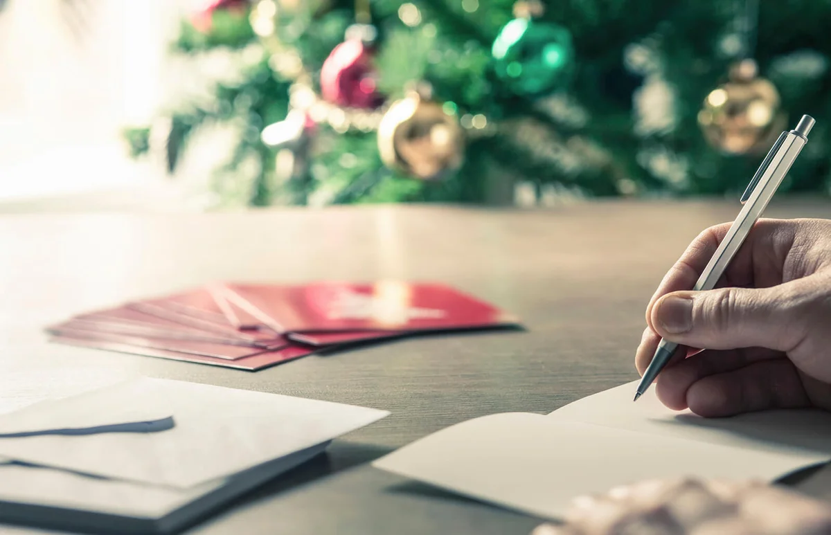 Person writing christmas cards