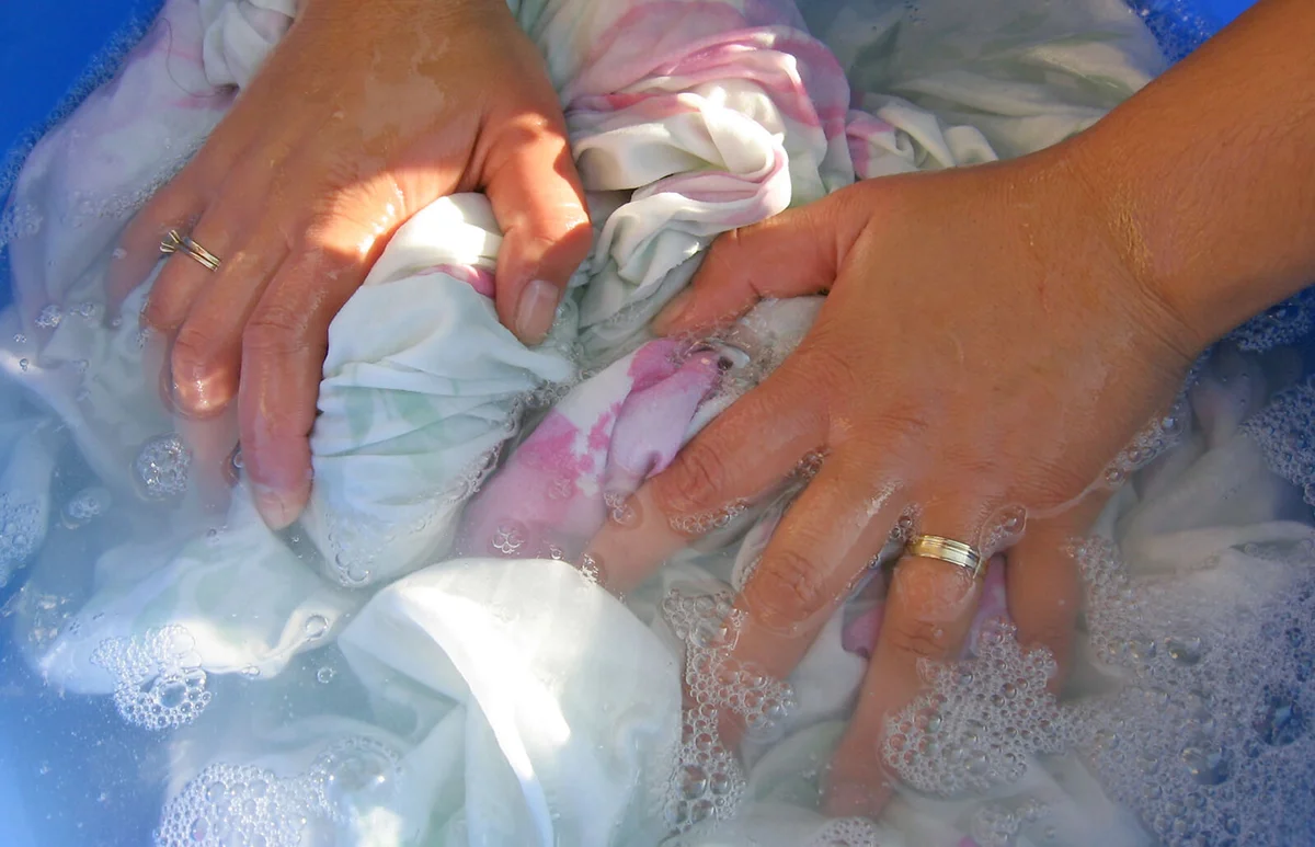 Woman hands washing clothes