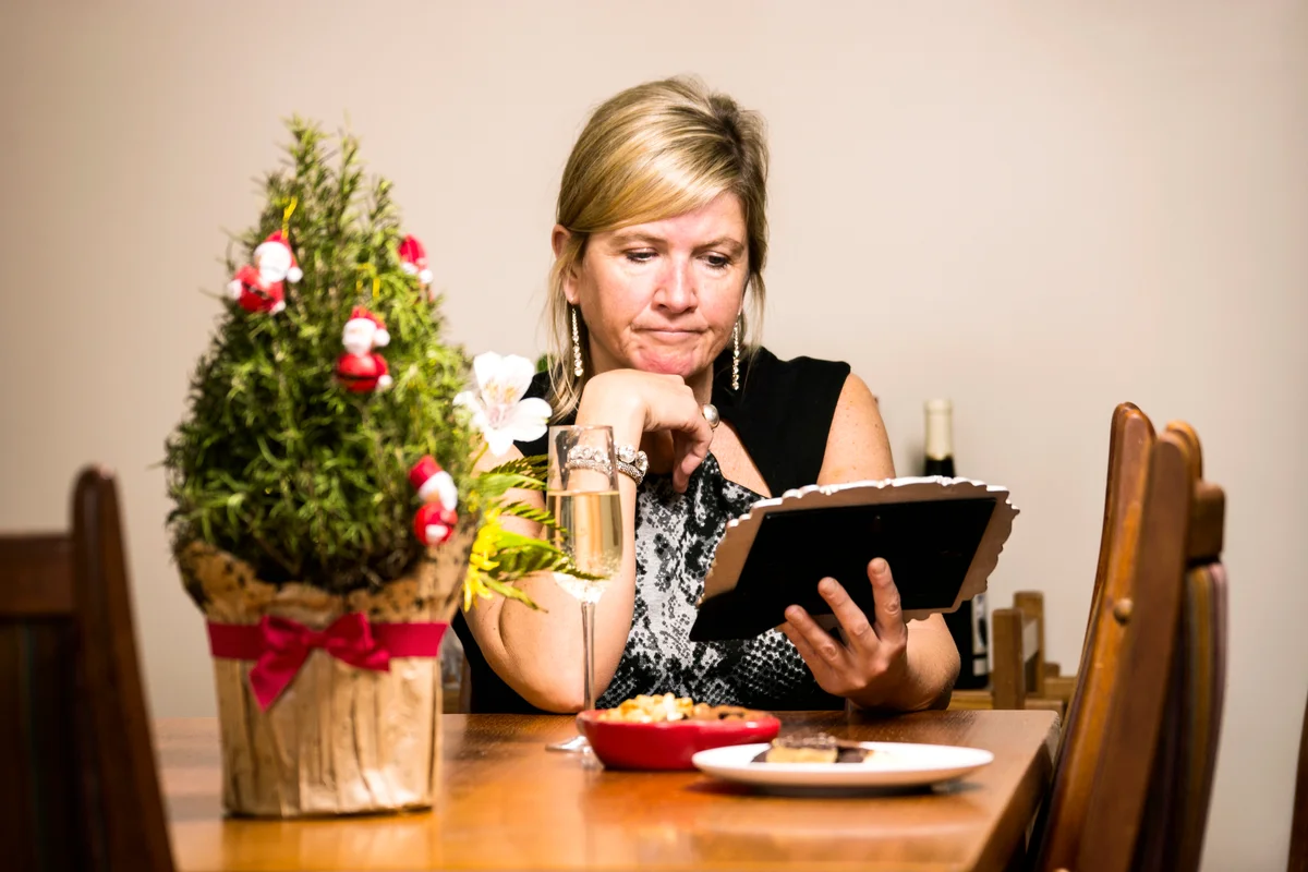 A middle-aged woman at home by her self at Christmas