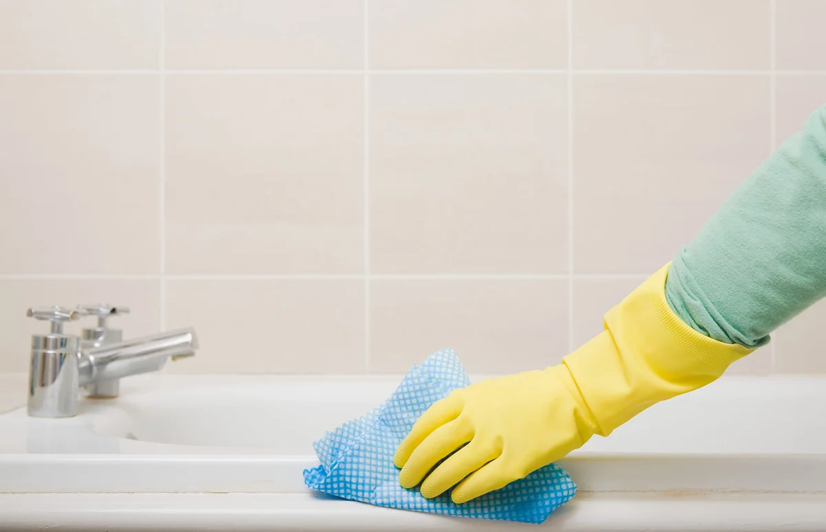 Person cleaning bath