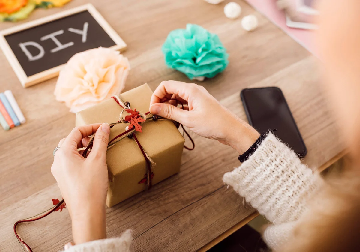 Young woman wrapping a gift