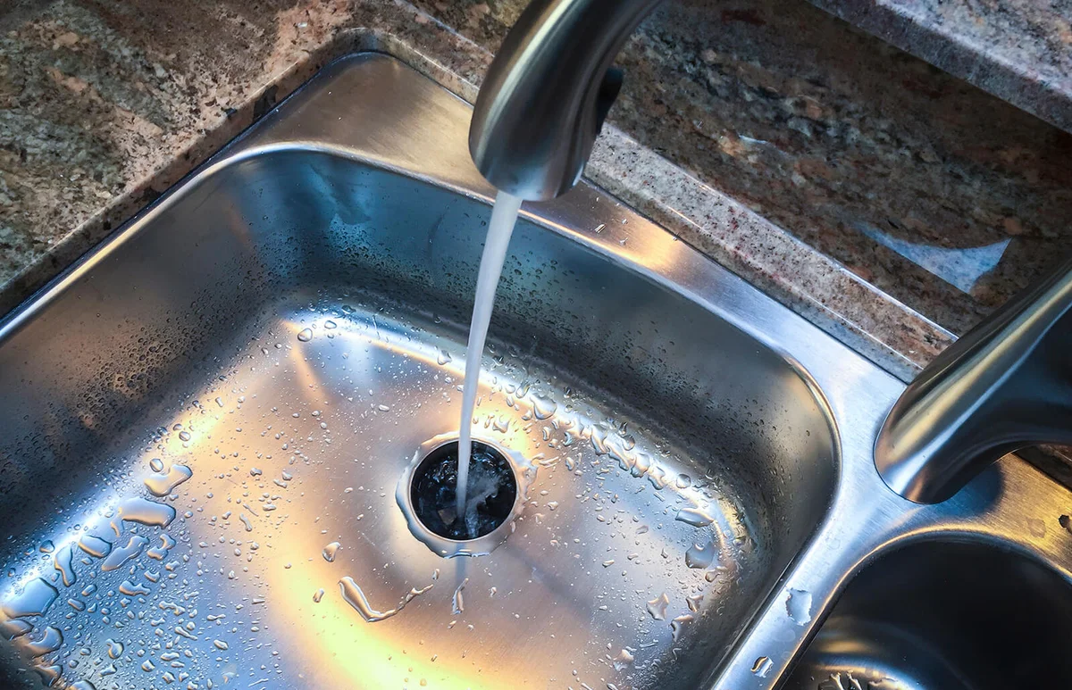 Water down the drain of kitchen sink
