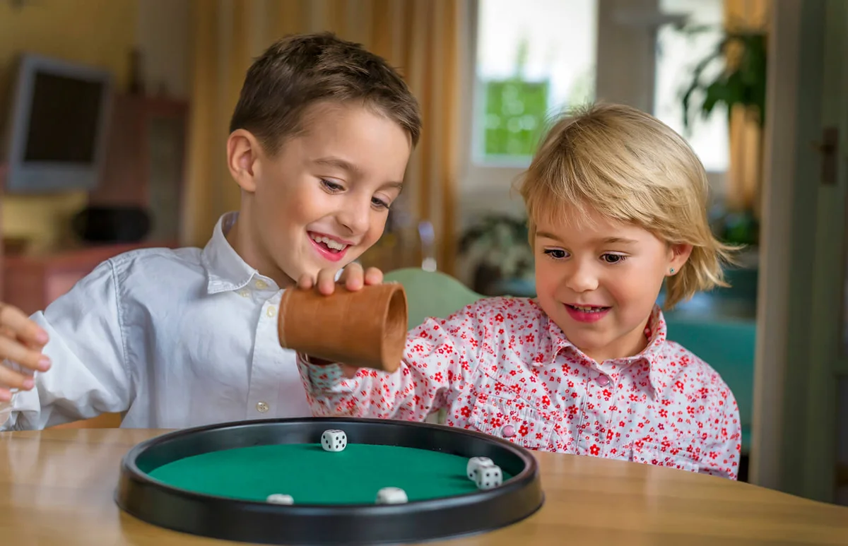 Brother and sister doing a game of dice together