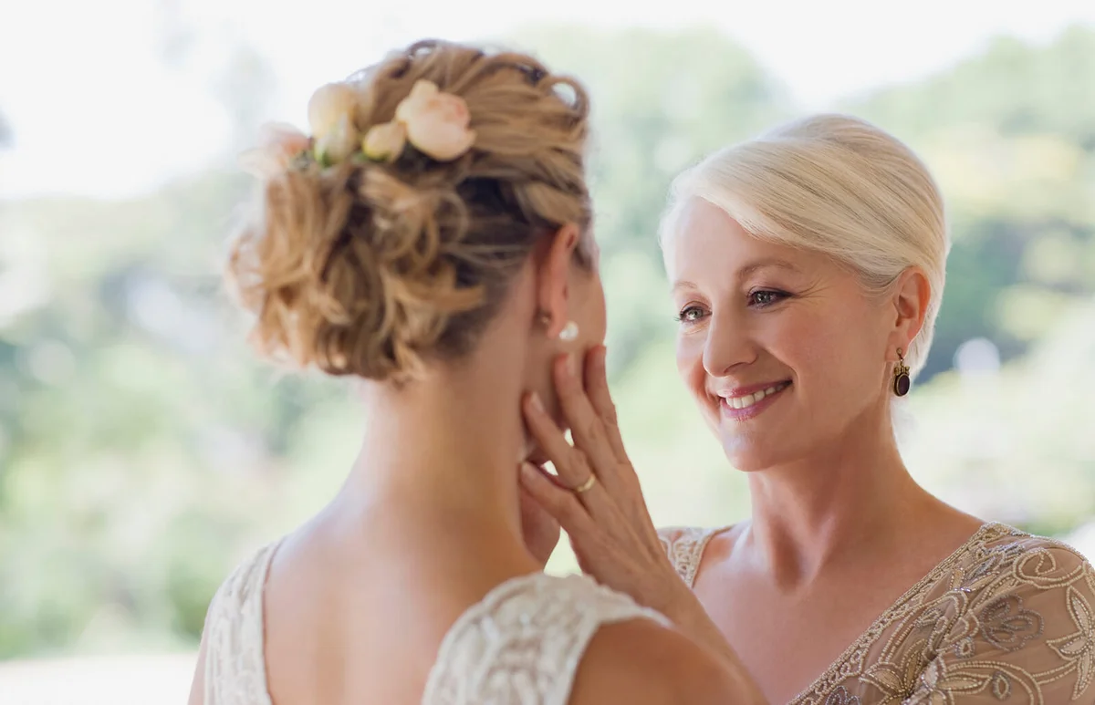 Mother touching brides face