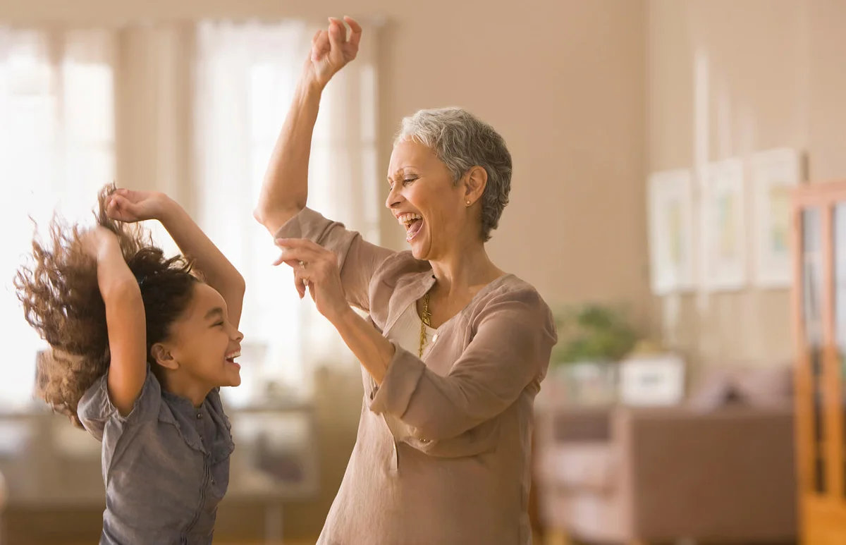 Grandmother and granddaughter dancing together