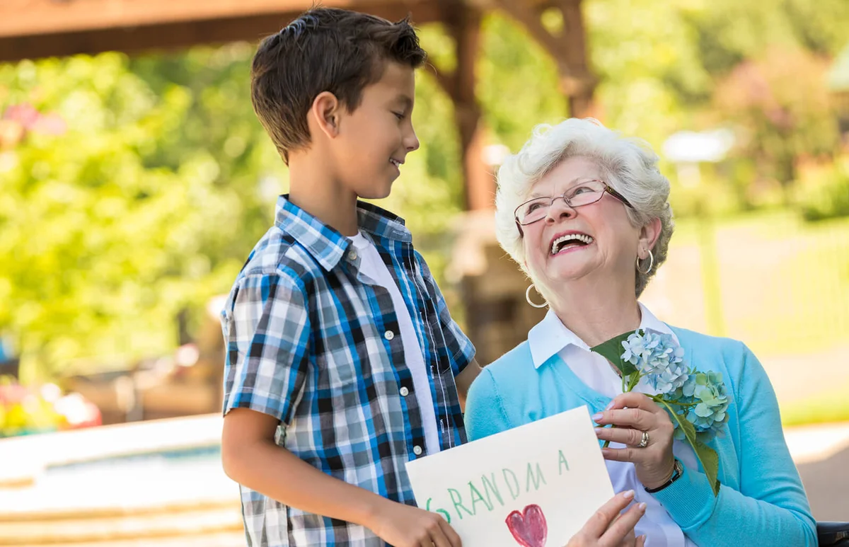 Loving grandmother looks up at her grandson