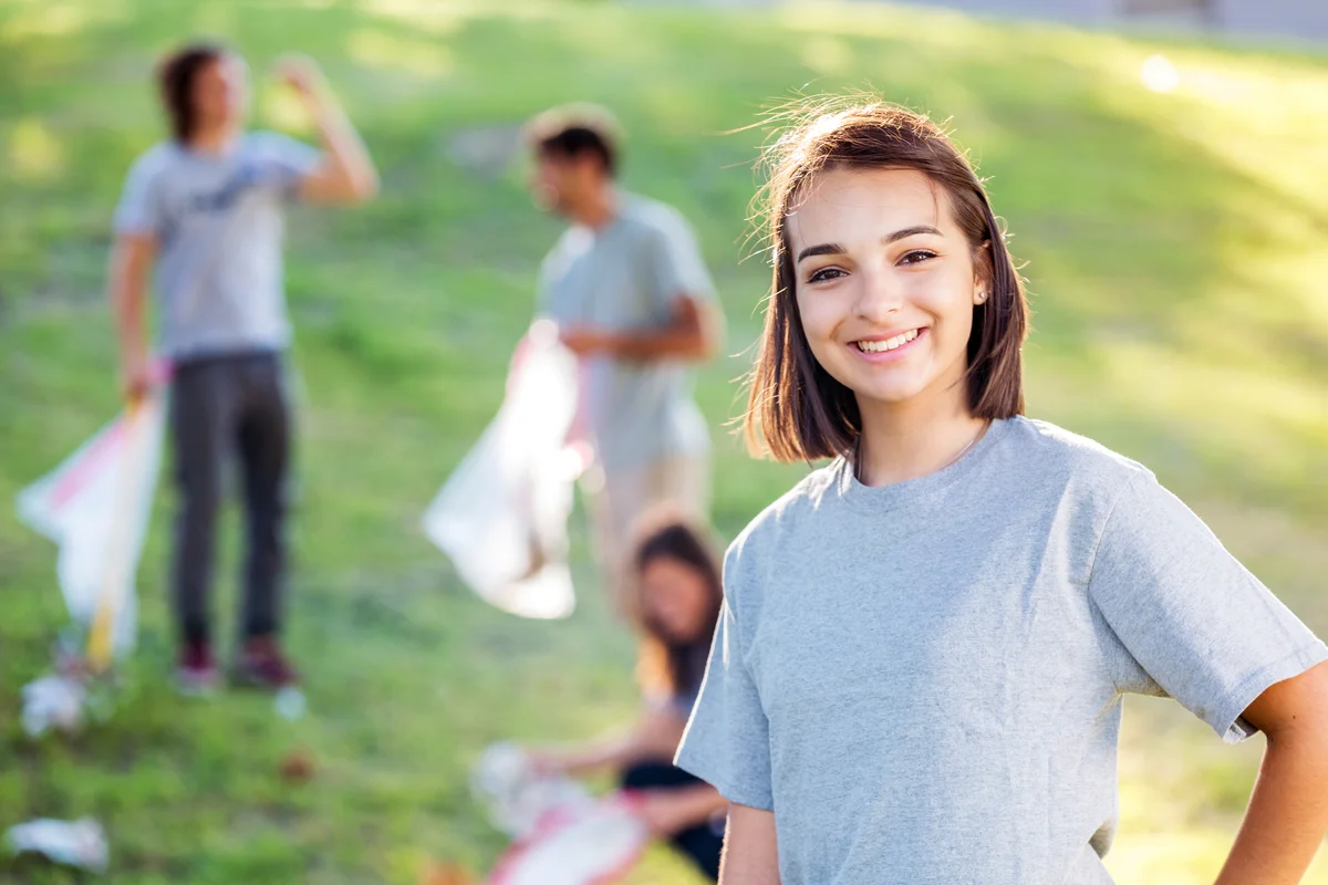 Teenager cleaning up a park