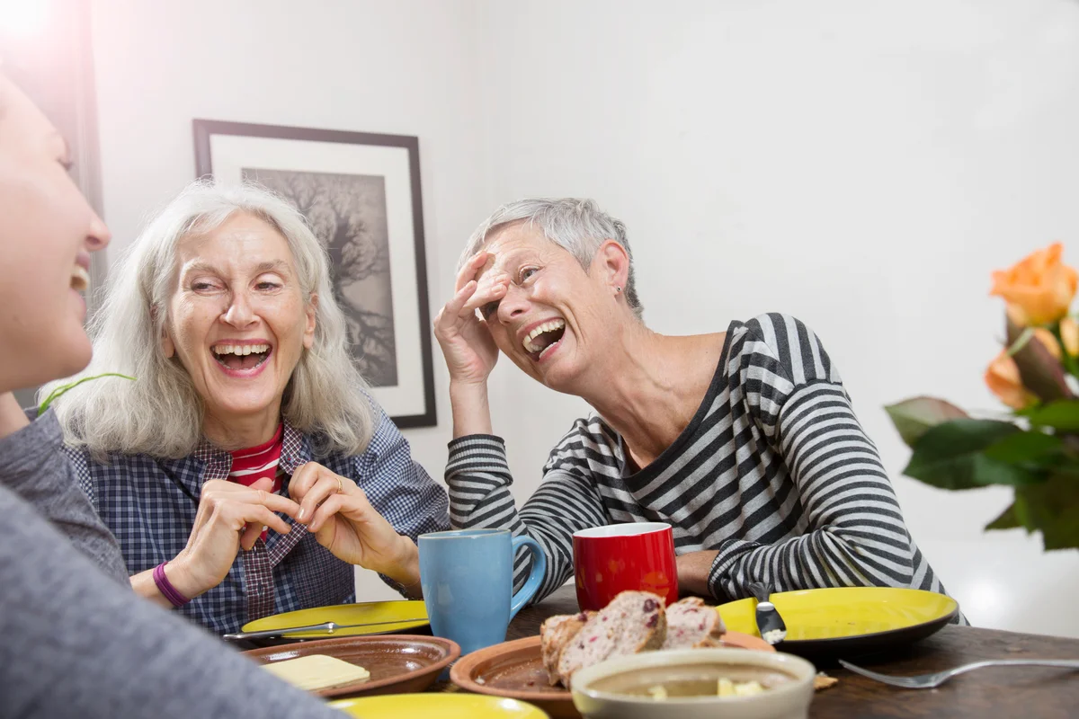 Women laughing, having lunch