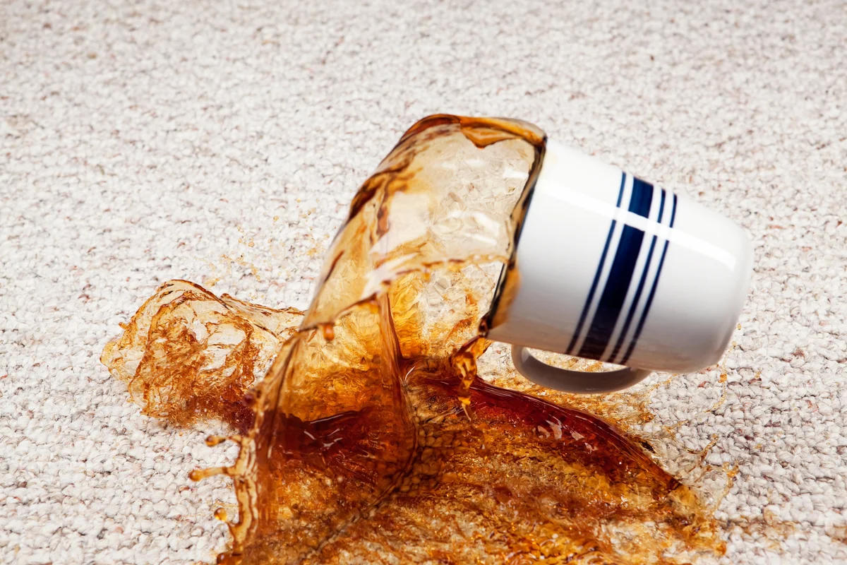 Coffee Spilling from Cup onto Carpet
