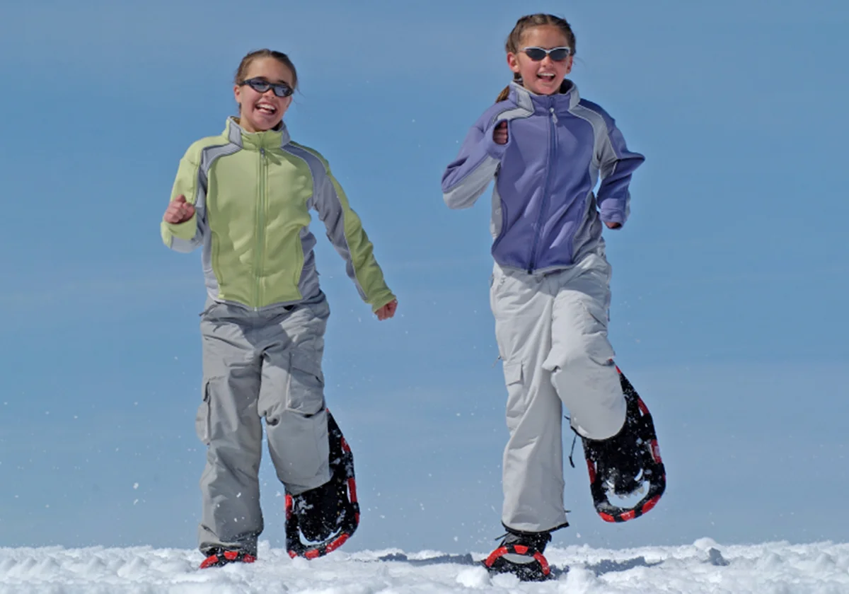 Two children snowshoeing