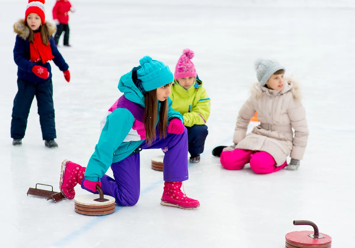 Young girls playing curling